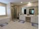 Luxurious bathroom featuring double sinks, a separate shower, and a soaking tub at 5157 Wellisford Ct, Suwanee, GA 30024