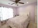 Cozy bedroom with a Paris themed bedspread, large window, and carpeted floors at 5157 Wellisford Ct, Suwanee, GA 30024