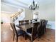 Formal dining room with a large table, seating for eight, and elegant chandelier at 5157 Wellisford Ct, Suwanee, GA 30024