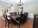 Open dining room with hardwood floors, decorative wainscoting, and a view of the staircase at 5157 Wellisford Ct, Suwanee, GA 30024