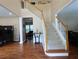 Two-story foyer with staircase, hardwood floors, and an elegant chandelier at 5157 Wellisford Ct, Suwanee, GA 30024
