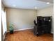 Bright home office featuring hardwood floors, neutral walls, and a functional workspace setup at 5157 Wellisford Ct, Suwanee, GA 30024