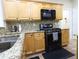 Well-equipped kitchen with stainless steel appliances and granite countertops at 5157 Wellisford Ct, Suwanee, GA 30024