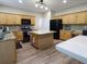 Spacious kitchen featuring a center island, granite countertops, and wood cabinets at 5157 Wellisford Ct, Suwanee, GA 30024