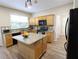 Modern kitchen with granite countertops, stainless steel appliances, and a center island at 5157 Wellisford Ct, Suwanee, GA 30024