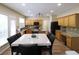 Bright kitchen with wood cabinets, granite countertops, and a functional island at 5157 Wellisford Ct, Suwanee, GA 30024