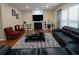 Comfortable living room features a fireplace, hardwood floors, and a plush rug at 5157 Wellisford Ct, Suwanee, GA 30024