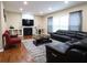 Spacious living room with a fireplace, large windows, and modern furnishings at 5157 Wellisford Ct, Suwanee, GA 30024