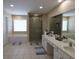 Spacious Primary bathroom with dual sinks, a soaking tub, a separate shower, and neutral tiling at 5157 Wellisford Ct, Suwanee, GA 30024