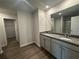 Granite-topped double vanity offers ample space and is next to walk-in closet and modern shower at 15 Fontana Ct, Covington, GA 30016