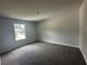Cozy bedroom with soft carpet, bright natural light, and neutral wall color at 15 Fontana Ct, Covington, GA 30016