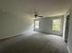 Spacious bedroom with plush carpet, ample natural light, and a ceiling fan at 15 Fontana Ct, Covington, GA 30016