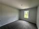 A carpeted bedroom provides a peaceful and cozy space with natural light at 15 Fontana Ct, Covington, GA 30016