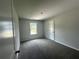 This is a clean and cozy carpeted bedroom with a view at 15 Fontana Ct, Covington, GA 30016