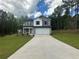 Charming two-story home with gray siding, white accents, and a spacious two-car garage at 15 Fontana Ct, Covington, GA 30016
