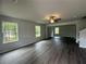 Living room featuring hardwood floors, bright windows, and overhead lighting at 15 Fontana Ct, Covington, GA 30016