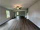 Bright living room featuring hardwood floors, a ceiling fan, and large windows at 15 Fontana Ct, Covington, GA 30016
