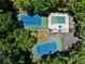 Aerial view of a community pool and tennis courts surrounded by lush greenery at 1956 Regents Way, Marietta, GA 30062
