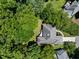 Aerial view of a home featuring a well-maintained roof, driveway, and surrounding lush greenery at 1956 Regents Way, Marietta, GA 30062