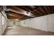 Unfinished basement with visible pipes, wood framing, and a door to outside at 1956 Regents Way, Marietta, GA 30062