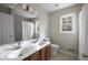 Bathroom with a double sink vanity, large mirror, and a window over toilet at 1956 Regents Way, Marietta, GA 30062