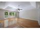 Spacious bedroom featuring hardwood floors, ceiling fan, tray ceiling, and access to a private deck at 1956 Regents Way, Marietta, GA 30062