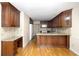 Well-appointed kitchen showcasing rich wood cabinets, granite counters, and gleaming hardwood flooring at 1956 Regents Way, Marietta, GA 30062