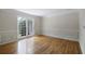 Sunlit living room with beautiful hardwood floors, large window, and classic wall paneling at 1956 Regents Way, Marietta, GA 30062