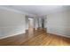 Open-concept living room with hardwood floors, neutral paint, and elegant wainscoting at 1956 Regents Way, Marietta, GA 30062