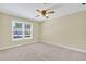 Spacious bedroom with neutral walls, carpet flooring, and natural light from the window at 4177 Elder Ln, Duluth, GA 30096