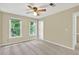 Cozy bedroom with carpeted floors, ceiling fan, two large windows letting in ample natural light at 4177 Elder Ln, Duluth, GA 30096