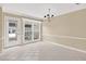 Bright dining room featuring neutral tile floor, chandelier, white trim, and sliding glass door to patio at 4177 Elder Ln, Duluth, GA 30096
