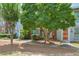 Charming townhome exteriors with sidewalks, mature trees, and inviting colorful front doors at 4177 Elder Ln, Duluth, GA 30096