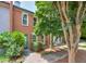Charming townhome with brick facade, mature landscaping, and inviting blue front door at 4177 Elder Ln, Duluth, GA 30096