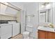 Functional laundry room featuring laundry machines and storage space at 4177 Elder Ln, Duluth, GA 30096