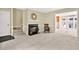 Bright living room featuring neutral carpet, fireplace, staircase, and views into the dining room at 4177 Elder Ln, Duluth, GA 30096