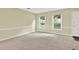 Spacious living room with neutral carpet, large windows providing natural light and white trim at 4177 Elder Ln, Duluth, GA 30096