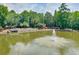 Scenic pond view with a water fountain and trees providing shade along the perimeter at 4177 Elder Ln, Duluth, GA 30096