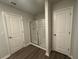 Bathroom showcasing a walk-in shower featuring glass doors, wood-look flooring, and natural lighting at 80 Heyman Dr, Covington, GA 30016