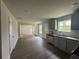Open living space featuring hardwood floors, connecting to a kitchen with modern appliances at 80 Heyman Dr, Covington, GA 30016