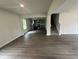 Open-concept living space with hardwood floors, seamlessly flowing into the kitchen and staircase at 80 Heyman Dr, Covington, GA 30016