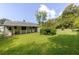 Expansive backyard featuring a lush lawn, mature trees, and a charming home with a covered porch at 849 N Park Ave, Marietta, GA 30060
