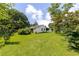 Lush backyard showcases a charming home with a well-maintained lawn and mature trees, offering a peaceful retreat at 849 N Park Ave, Marietta, GA 30060