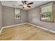 Comfortable bedroom featuring hardwood floors, a ceiling fan, and two windows with natural light at 849 N Park Ave, Marietta, GA 30060