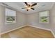 Cozy bedroom with hardwood floors, two windows, and a ceiling fan for added comfort at 849 N Park Ave, Marietta, GA 30060