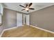 Neutral bedroom featuring hardwood floors, a ceiling fan, and access to multiple closets at 849 N Park Ave, Marietta, GA 30060