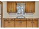 Kitchen sink features oak cabinets and a window letting in natural light at 849 N Park Ave, Marietta, GA 30060