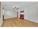 Bright living room features wood floors, red brick fireplace, ceiling fan and a wall mounted tv at 849 N Park Ave, Marietta, GA 30060