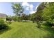 A spacious green yard, dotted with trees, creates a serene and inviting outdoor space at 849 N Park Ave, Marietta, GA 30060