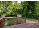 A fenced backyard with a storage shed, green lawn, and a wooden deck at 2732 Arbor Se Ave, Atlanta, GA 30317